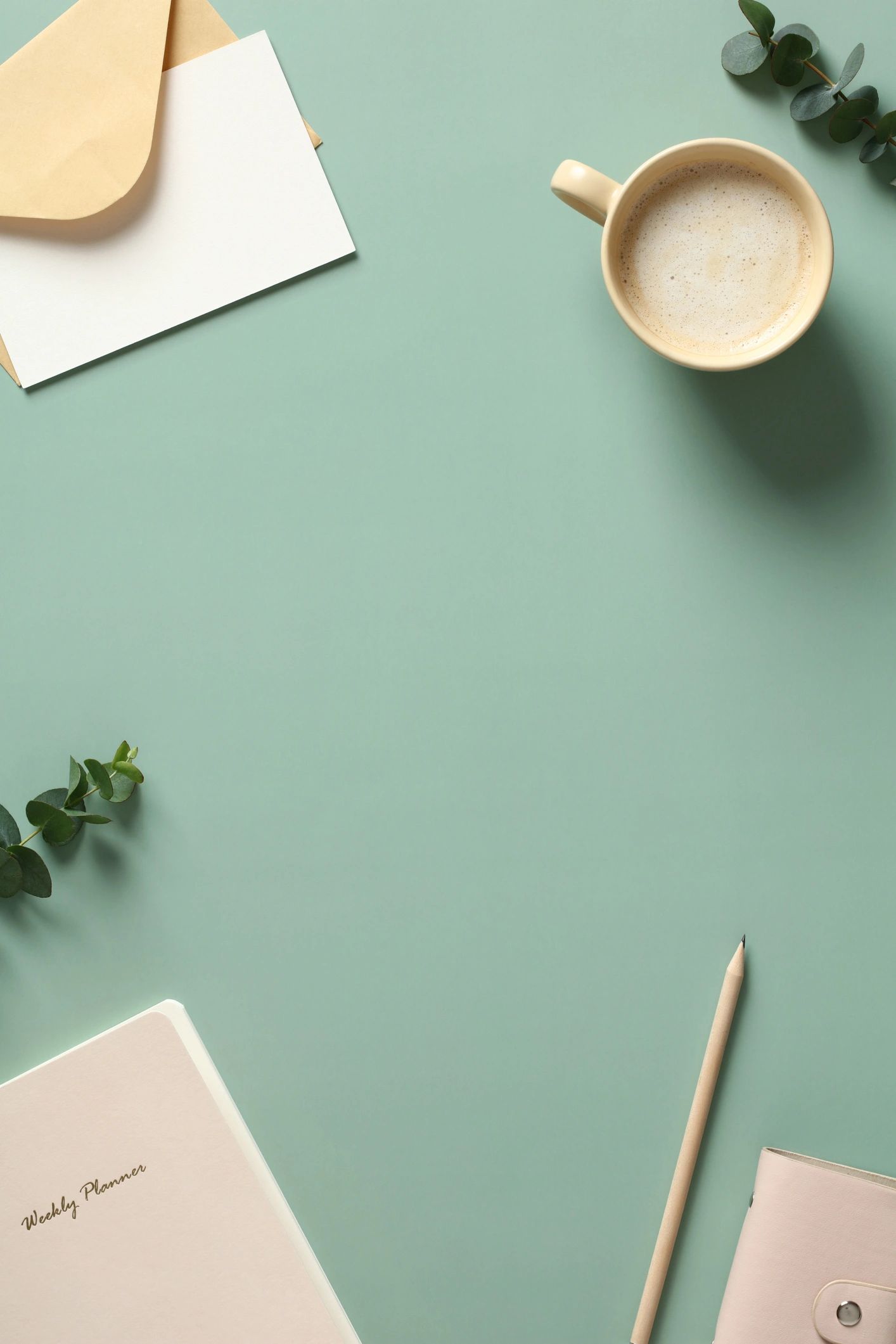 Flat lay of a planning desk with notebook and coffee, representing organized creative work.