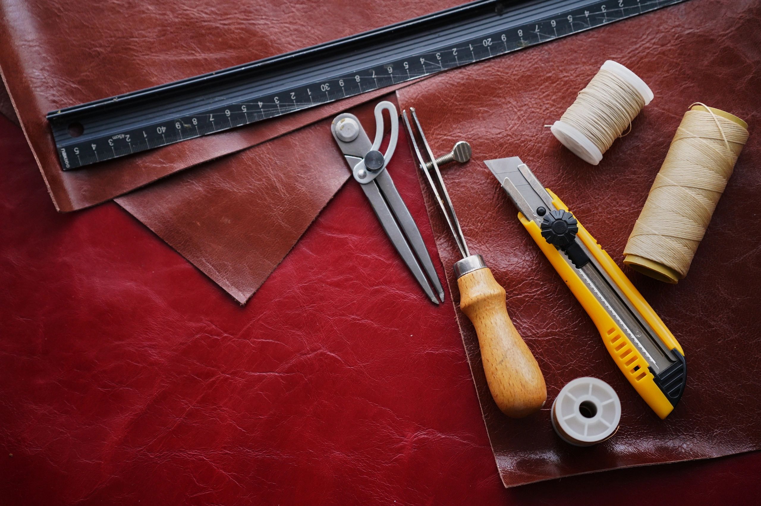 Leathercraft tools and materials on a work surface